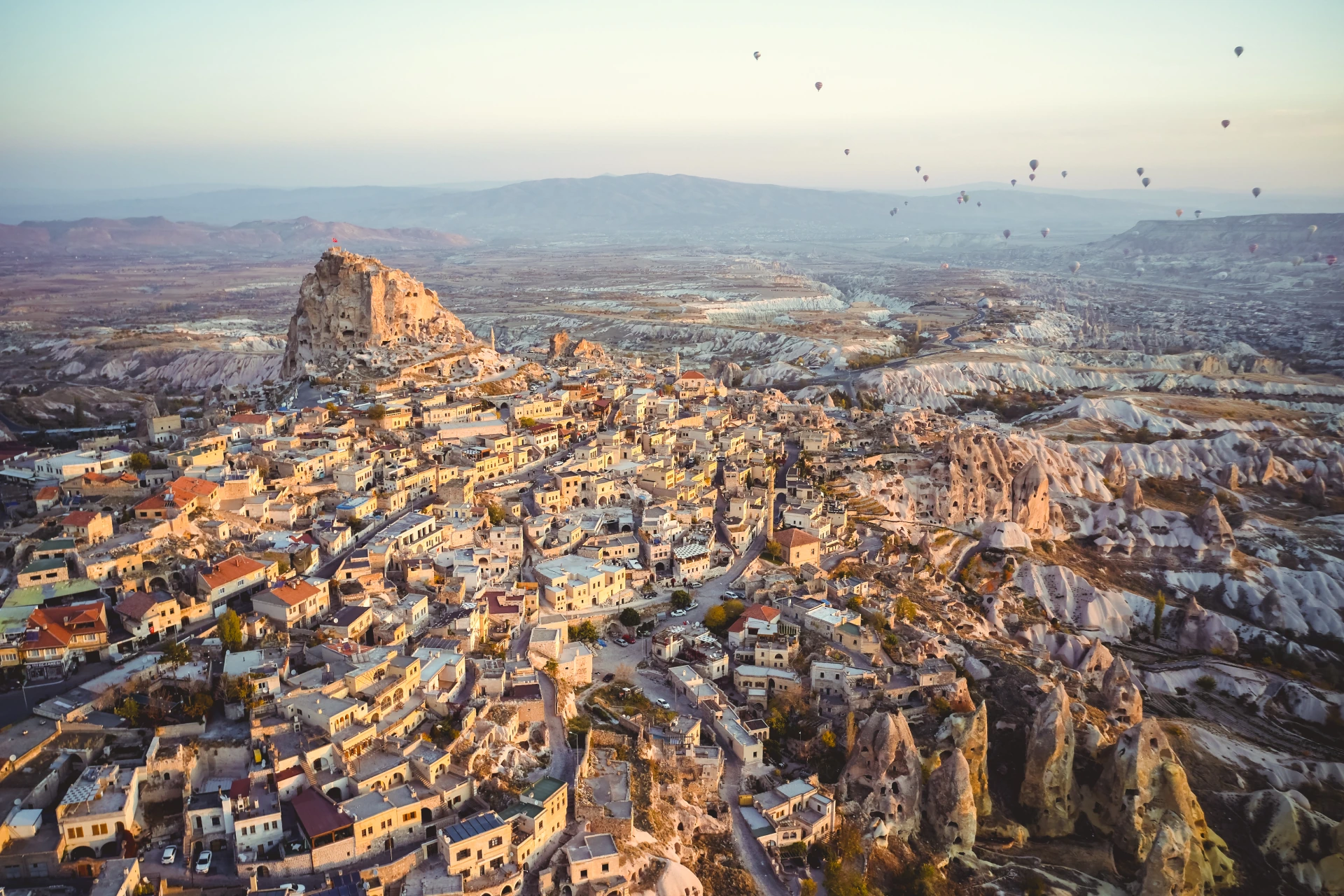 Sunrise above the landscapes and hot-air balloons of Cappadocia